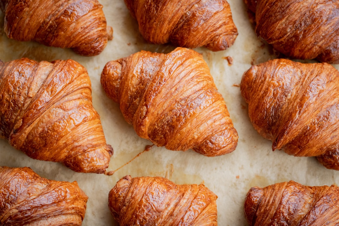 Freshly baked croissants piled on a table