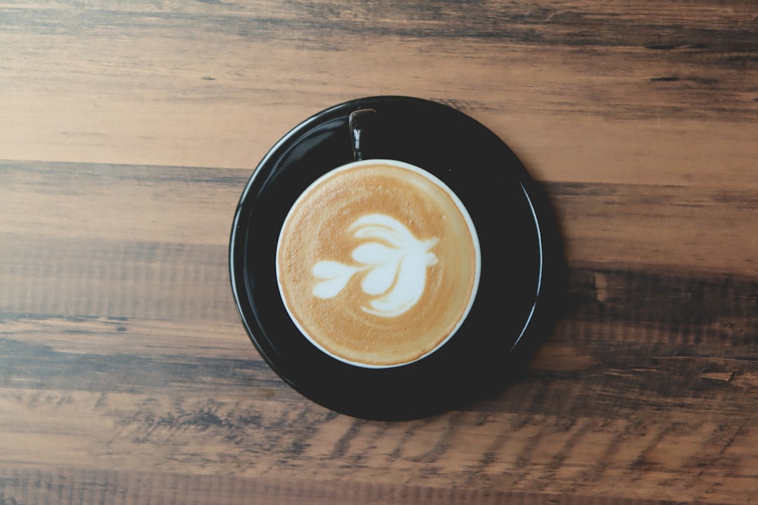 Flat white with latte art on a wooden table